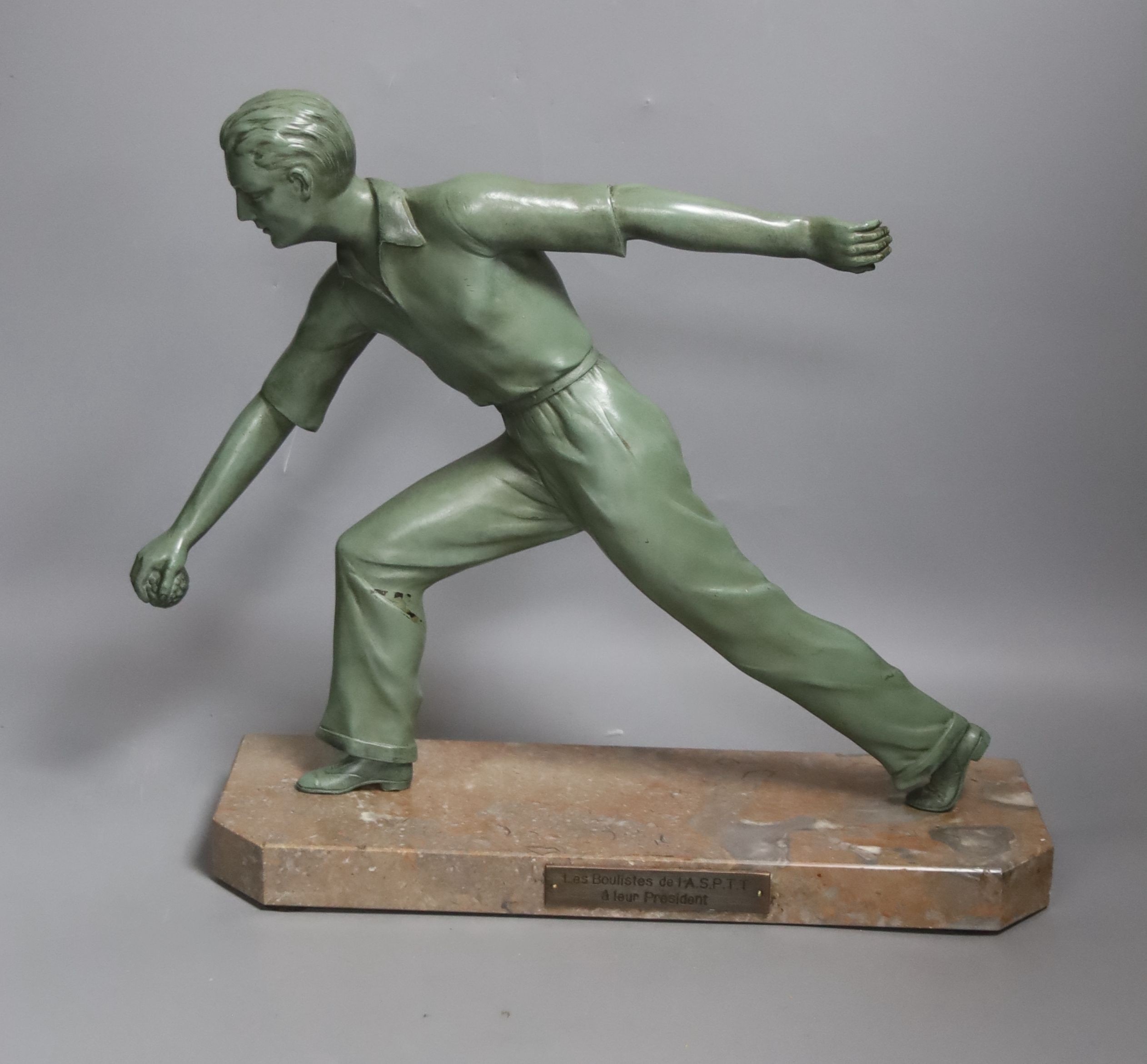 An Art Deco model of a gentleman playing boules. Marble base with plaque reading ‘Les boulistes de l-A.S.P.T.T a leur President’ - 33.5cm
